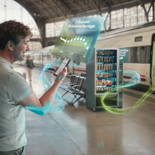 Mann am Bahnhof sieht sich die Glukosevorhersage auf seinem Handy an
